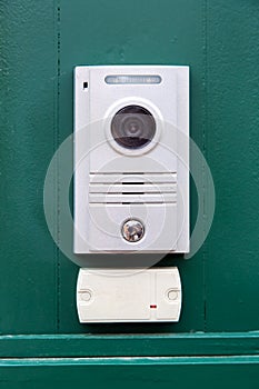 An intercom with a video camera and a microphone.