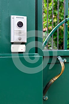 An intercom with a video camera and a microphone.