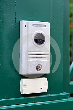 An intercom with a video camera and a microphone.