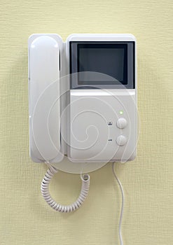 Intercom on yellow wall