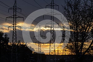 Interconnected Web of Electrical Towers Against a Sunset Sky