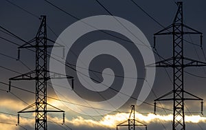 Interconnected Web of Electrical Towers Against a Sunset Sky