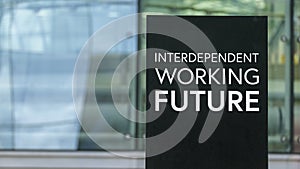 Interdependent Working Future on a sign outside a modern glass office building