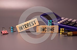 INTEREST INCOME text on notebook with pen on a chart background photo