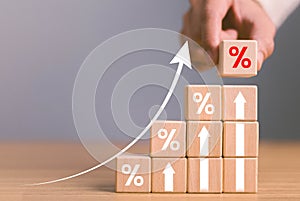 Interest rate financial and mortgage rates concept. Wooden blocks with Icon percentage symbol and arrow pointing up. company