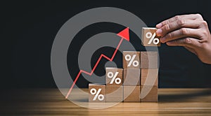 Interest rate financial and mortgage rates concept. Wooden blocks with Icon percentage symbol and arrow pointing up. company