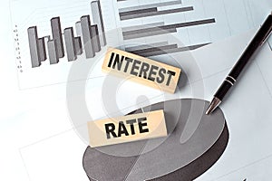 INTEREST RATE text on wooden block on chart background