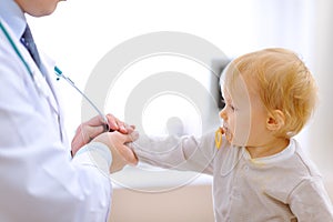 Interested baby stretching for stethoscope