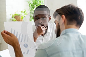 Interested black client listening to financial advisor explainin