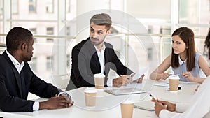 Interested colleagues listen to employee talk at company meeting