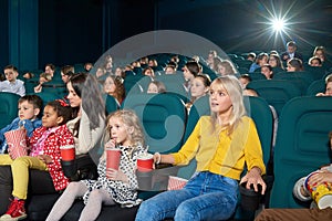 Interested girls watching new movie in the cinema.