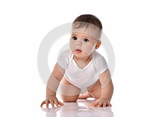 Interested infant baby in white cotton bodysuit is crawling toward us on all fours