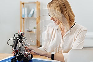 Interested inventor working with electronic robot in the studio