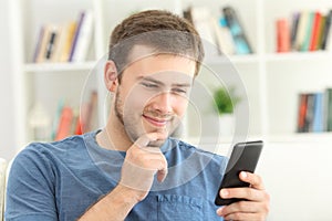 Interested man finding on line content on a smart phone