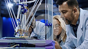 Researchers watching 3-D printing machine in process