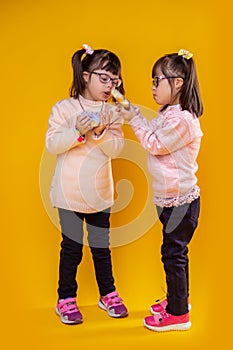Adorable little girls playing with proposed food photo