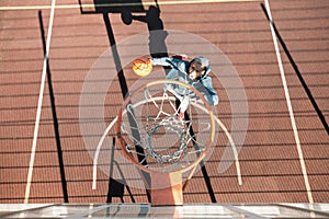 Top view of a nice young man playing basketball photo