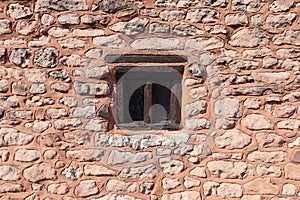 An interesting old window in a stone wall in the village of Nether Stowey in Somerset, United Kingdom