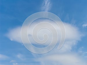 Interesting oval white cloud in blue sky