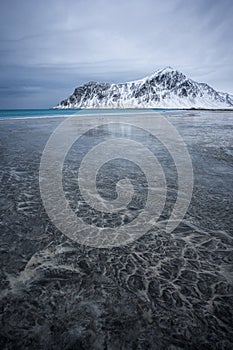 Interesting patterns and textures left by fading ebbs on the Skagsanden beach, Lofoten