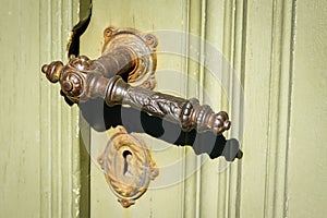 Interesting shaped old metal door handle for wooden doors