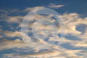 Interesting shapes of wispy clouds in blue sky