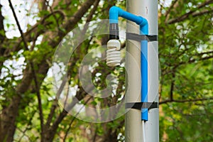 An interesting solution to repairing a high and unreachable, broken, Thai park light pole, using simple materials.