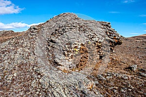 An interesting stone in the steppe with layers with an interesting structure.