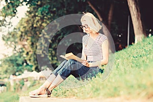 Interesting story. Relax and get new information. student girl with book outdoor. woman in park reading book. inspired