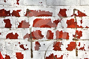 Interesting structure of a red stone wall with paint residues for abstract backgrounds.