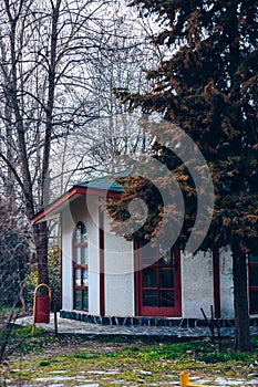 An interesting teahouse building in Bulgaria. Teahouse, souvenir shop in a park between trees.