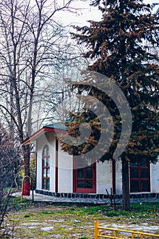 An interesting teahouse building in Bulgaria. Teahouse, souvenir shop in a park between trees.