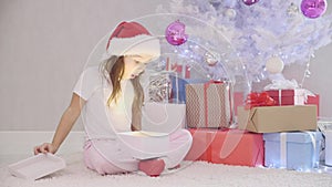 Interesting video of pretty kid slealing a gift box fom under the christmas tree at night.