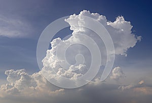 Interesting white cumulus clouds pattern against the clear blue sky background