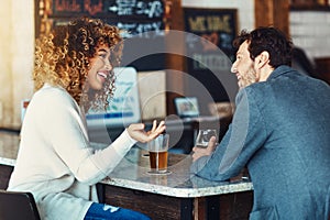 Interesting that you say that. a couple enjoying a drink at a bar.