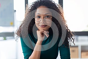 Interesting young woman looking at camera in the office