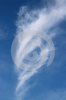 Interestingly shaped wispy feathery white cloud photo