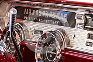 The interior of a 1957 Pontiac Star Chief in red and white