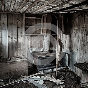 Interior of an abandoned hut with ruined stove