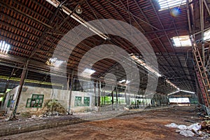 Interior of abandoned steel frame workshop factory building in industrial area