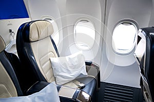 The interior of the aircraft. Empty airplane cabin. Seats for passengers in the business class compartment