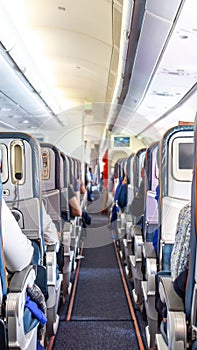 Interior of airplane with passengers on seats during flight