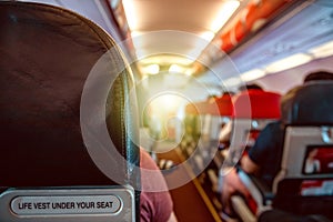 Interior of an airplane with passengers on seats waiting for takeoff