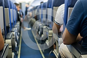 Interior of airplane with passengers on seats waiting to taik of