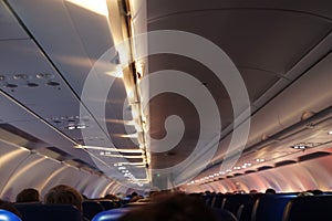 Interior of airplane with passengers on seats waiting to taik off.