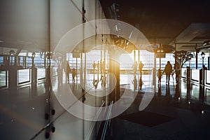 Interior of airport with people silhouettes