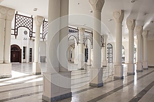 Interior of Al Hussein Bin Ali Mosque in Aqaba, Jordan. White marble colonnade of masjid.