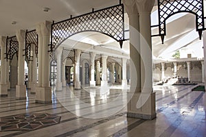 Interior of Al Hussein Bin Ali Mosque in Aqaba, Jordan. White marble colonnade of masjid.