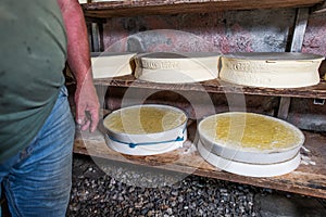 Interior of an alpine hut with typical forms of local cheese