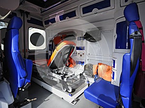 Interior of an ambulance car: stretcher, bags, medical equipment